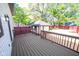 Spacious stained wood deck overlooking the backyard with storage shed at 402 N Oxford St, Indianapolis, IN 46201