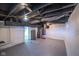 Unfinished basement featuring exposed rafters and ductwork at 402 N Oxford St, Indianapolis, IN 46201