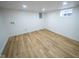 Finished basement area with modern flooring and a window allowing natural light at 402 N Oxford St, Indianapolis, IN 46201
