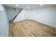 Open basement area with modern flooring, white walls and access to stairs at 402 N Oxford St, Indianapolis, IN 46201