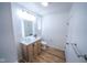 A stylish bathroom with decorative lighting and a white tiled shower and floor at 402 N Oxford St, Indianapolis, IN 46201