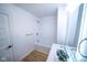 Bathroom with wooden floor, white shower and large mirror over the sink at 402 N Oxford St, Indianapolis, IN 46201