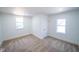 Bright bedroom featuring neutral carpet, white trim, and two windows providing natural light at 402 N Oxford St, Indianapolis, IN 46201