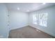 Bedroom features neutral walls, carpeting, and two windows for lots of natural light at 402 N Oxford St, Indianapolis, IN 46201