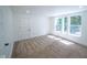 Light-filled bedroom with three windows, plush carpeting, and white trim at 402 N Oxford St, Indianapolis, IN 46201