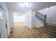 Bright entryway with hardwood floors, a staircase, and an open floor plan at 402 N Oxford St, Indianapolis, IN 46201