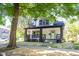 Charming two-story home with a covered front porch, white siding, and black trim at 402 N Oxford St, Indianapolis, IN 46201