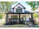 Charming two-story home with a welcoming front porch and landscaped yard at 402 N Oxford St, Indianapolis, IN 46201