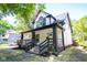 Charming home featuring a covered front porch and landscaped yard at 402 N Oxford St, Indianapolis, IN 46201