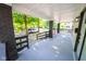 Spacious covered front porch with brick pillars and fresh paint at 402 N Oxford St, Indianapolis, IN 46201