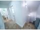 Upstairs hallway with carpeting, white walls, and doorways to bedrooms and bathroom at 402 N Oxford St, Indianapolis, IN 46201