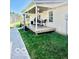 Backyard with a covered wooden deck with outdoor furniture, ideal for relaxing at 409 N Kyle St, Edinburgh, IN 46124