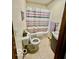 Bathroom features a tub and shower combination with a gray and pink patterned curtain at 409 N Kyle St, Edinburgh, IN 46124