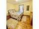 Cozy bedroom with wood floors, a metal-framed bed, and two matching dressers at 409 N Kyle St, Edinburgh, IN 46124