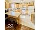 Kitchen featuring light wood cabinets, a center island, and tile flooring at 409 N Kyle St, Edinburgh, IN 46124