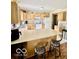 Well-lit kitchen featuring wood cabinets, a spacious countertop, and an island with seating at 409 N Kyle St, Edinburgh, IN 46124