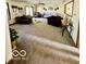 The open-concept living room is filled with natural light and plush carpet at 409 N Kyle St, Edinburgh, IN 46124