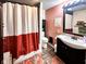 Bathroom with decorative shower curtain, dark wood vanity and a large mirror at 430 W Locust St, Shelbyville, IN 46176