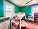 Stylish bedroom features a playful loft bed with a vanity, and bright teal walls at 430 W Locust St, Shelbyville, IN 46176