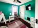 Bright bedroom features a ceiling fan, mounted television, and a large window for natural light at 430 W Locust St, Shelbyville, IN 46176