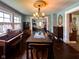 Open dining room with hardwood floors, vintage cabinets, and piano at 430 W Locust St, Shelbyville, IN 46176