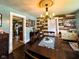 Charming dining room with rustic wood wall, vintage cabinets, and unique chandelier at 430 W Locust St, Shelbyville, IN 46176