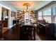 Elegant dining room with vintage chandelier, wood accent wall, and large windows at 430 W Locust St, Shelbyville, IN 46176