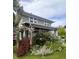Quaint two-story home featuring beautiful flower garden, and wooden pergola at 430 W Locust St, Shelbyville, IN 46176