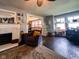 Well lit room featuring a fireplace, a patterned rug, and easy access to an office area and dining room at 430 W Locust St, Shelbyville, IN 46176