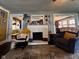 Bright living room featuring a fireplace, a comfortable chair, a patterned rug, and easy access to the dining room at 430 W Locust St, Shelbyville, IN 46176