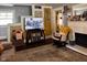 Cozy living room featuring a television, patterned rug, and fireplace, perfect for relaxation and entertainment at 430 W Locust St, Shelbyville, IN 46176
