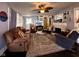 Inviting living room featuring a ceiling fan, patterned rug, fireplace, and comfortable seating for relaxation and entertainment at 430 W Locust St, Shelbyville, IN 46176