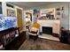 Cozy living room featuring a television, patterned rug, and fireplace, perfect for relaxation and entertainment at 430 W Locust St, Shelbyville, IN 46176