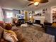 Inviting living room featuring a ceiling fan, patterned rug, fireplace, and comfortable seating for relaxation and entertainment at 430 W Locust St, Shelbyville, IN 46176