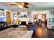 Bright living room featuring a fireplace, a comfortable chair, a patterned rug, and easy access to the dining room at 430 W Locust St, Shelbyville, IN 46176
