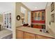 Stylish bar area with custom cabinetry, sink, counter space, and seamless transition to living spaces at 4704 Pearcrest Way, Greenwood, IN 46143