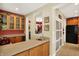 Convenient bar area with ample countertop, cabinet space, sink, and views into other rooms at 4704 Pearcrest Way, Greenwood, IN 46143