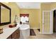 Well-lit bathroom featuring a soaking tub, vanity with sink, and tile flooring at 4704 Pearcrest Way, Greenwood, IN 46143
