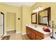 Bright bathroom showcasing a double vanity, glass shower, and neutral-toned flooring at 4704 Pearcrest Way, Greenwood, IN 46143
