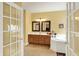 Well-lit bathroom with double sinks, a soaking tub, and a glass-enclosed shower at 4704 Pearcrest Way, Greenwood, IN 46143