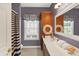 Bathroom with dual sinks, nautical themed decor and a large framed mirror above the sink at 4704 Pearcrest Way, Greenwood, IN 46143