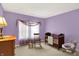 Bedroom with a crib, rocking chair, side table, and lavender walls, creating a serene space at 4704 Pearcrest Way, Greenwood, IN 46143