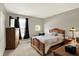 Bedroom featuring a bed, dresser, TV, and natural light at 4704 Pearcrest Way, Greenwood, IN 46143