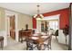 Charming dining area with a wooden table, buffet, and easy access to adjacent rooms for entertaining at 4704 Pearcrest Way, Greenwood, IN 46143