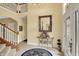 Inviting two-story foyer features tiled floor and elegant chandelier lighting at 4704 Pearcrest Way, Greenwood, IN 46143