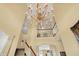 Bright foyer boasts a soaring ceiling with a chandelier and an open staircase at 4704 Pearcrest Way, Greenwood, IN 46143