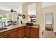 A view from the kitchen that includes a pass-through to a dining area and a glimpse of the staircase to the basement at 4704 Pearcrest Way, Greenwood, IN 46143