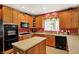 Modern kitchen equipped with wood cabinets, laminate counters, an island, and a full suite of appliances at 4704 Pearcrest Way, Greenwood, IN 46143
