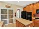 Contemporary kitchen showcasing wood cabinetry, an island, access to the pantry, and modern appliances at 4704 Pearcrest Way, Greenwood, IN 46143