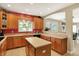 Spacious kitchen boasting wood cabinets, laminate countertops, a central island, and a view to the backyard at 4704 Pearcrest Way, Greenwood, IN 46143